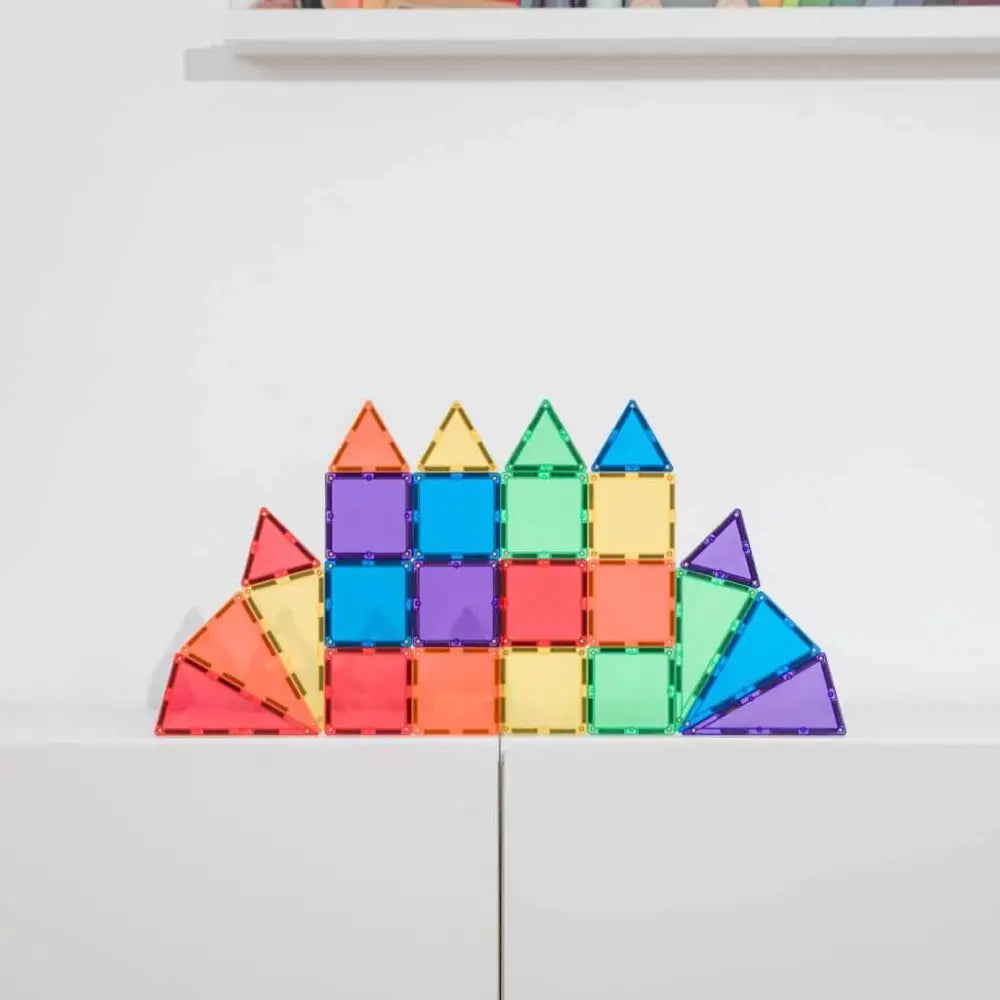 Colorful geometric construction made of magnetic tiles arranged in a symmetrical castle-like shape.