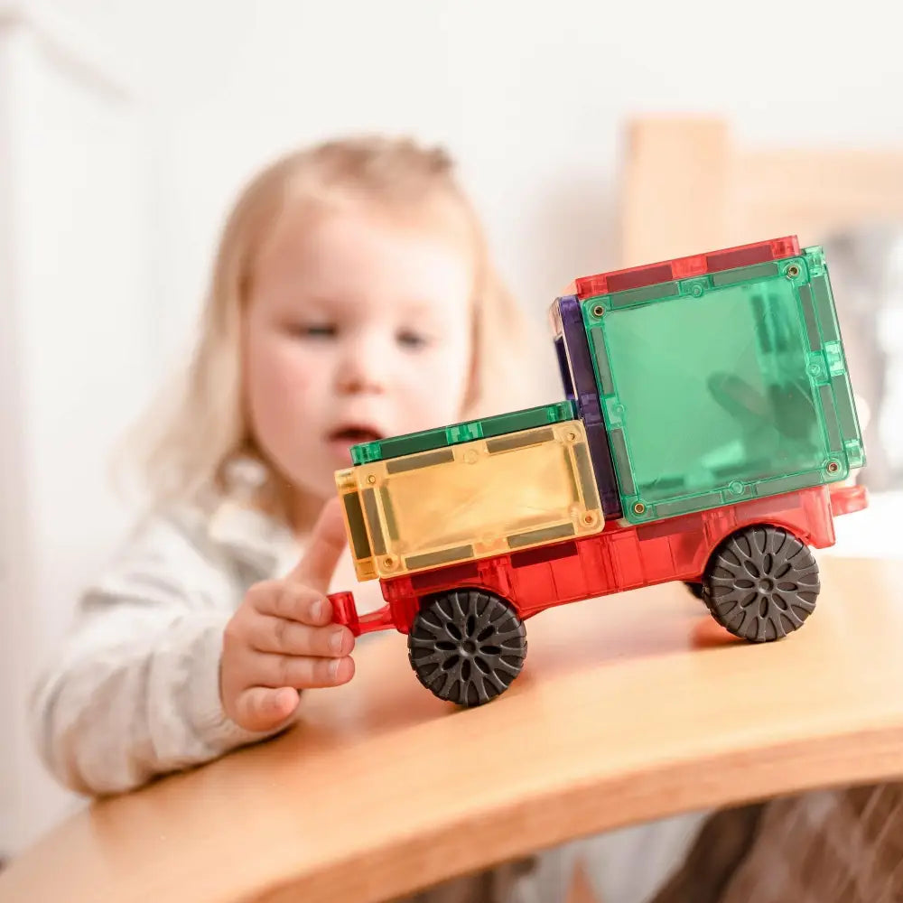 Colorful toy truck with transparent plastic blocks forming the cargo area.