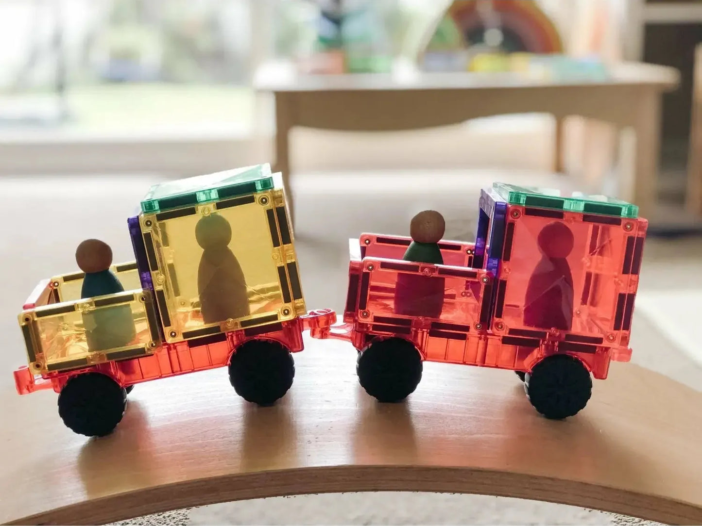 Colorful magnetic toy train with figurine passengers.