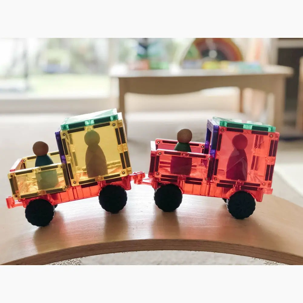 Colorful magnetic toy train with figurine passengers.