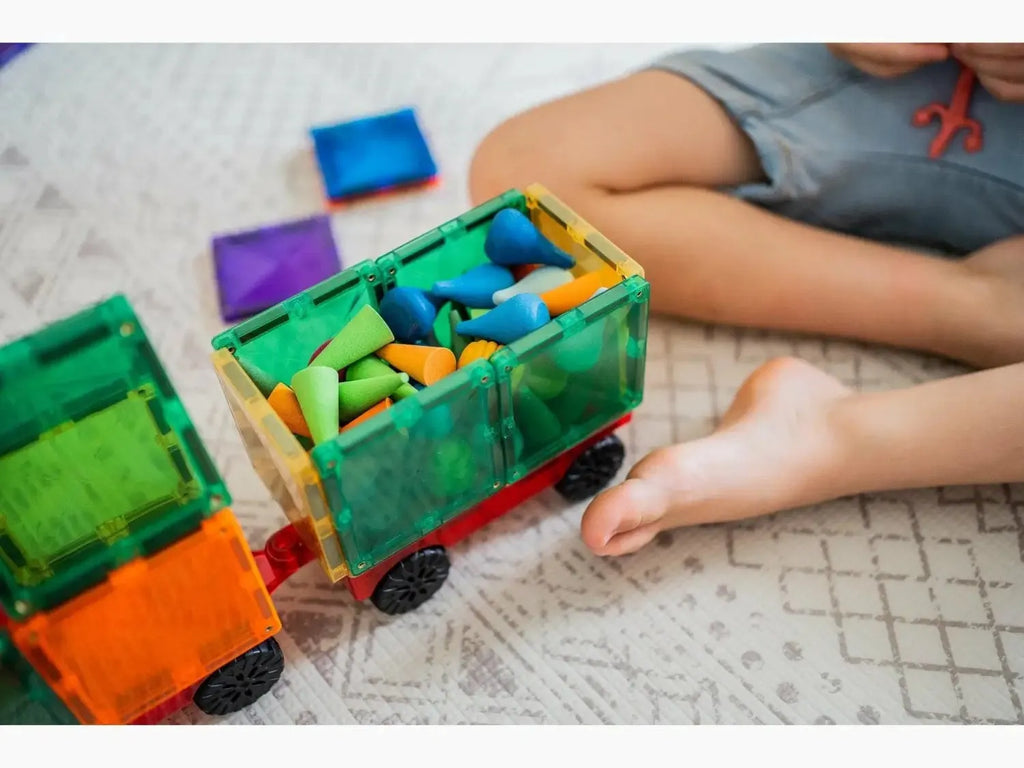 Colorful toy train with magnetic blocks in its compartments.