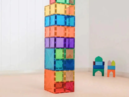 Colorful stack of transparent magnetic building tiles forming a tall tower.