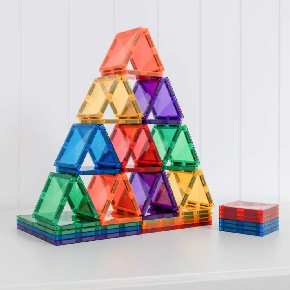 Colorful triangular magnetic building tiles stacked into a pyramid shape.