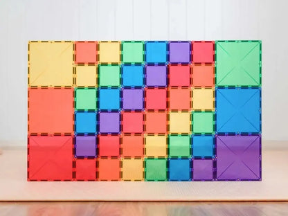 Colorful magnetic building tiles arranged in a rectangular pattern.