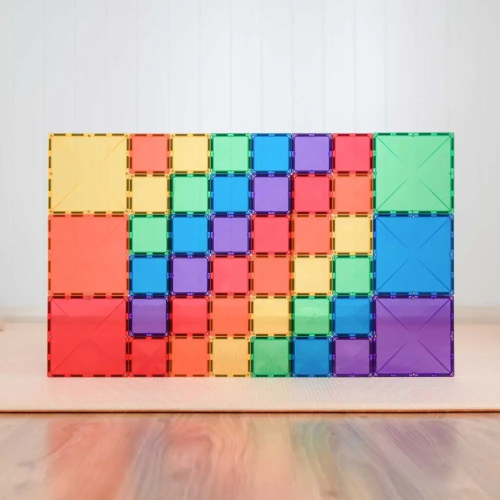 Colorful magnetic building tiles arranged in a rectangular pattern.