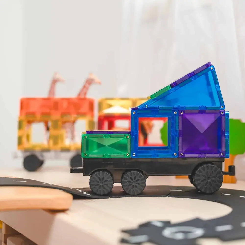 Colorful magnetic tile toy truck with geometric shapes forming the body and cargo area.