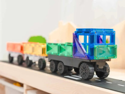 Colorful toy train made of magnetic building blocks on a track.
