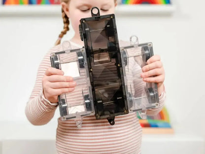 Clear plastic building blocks or construction toy with a central black piece.