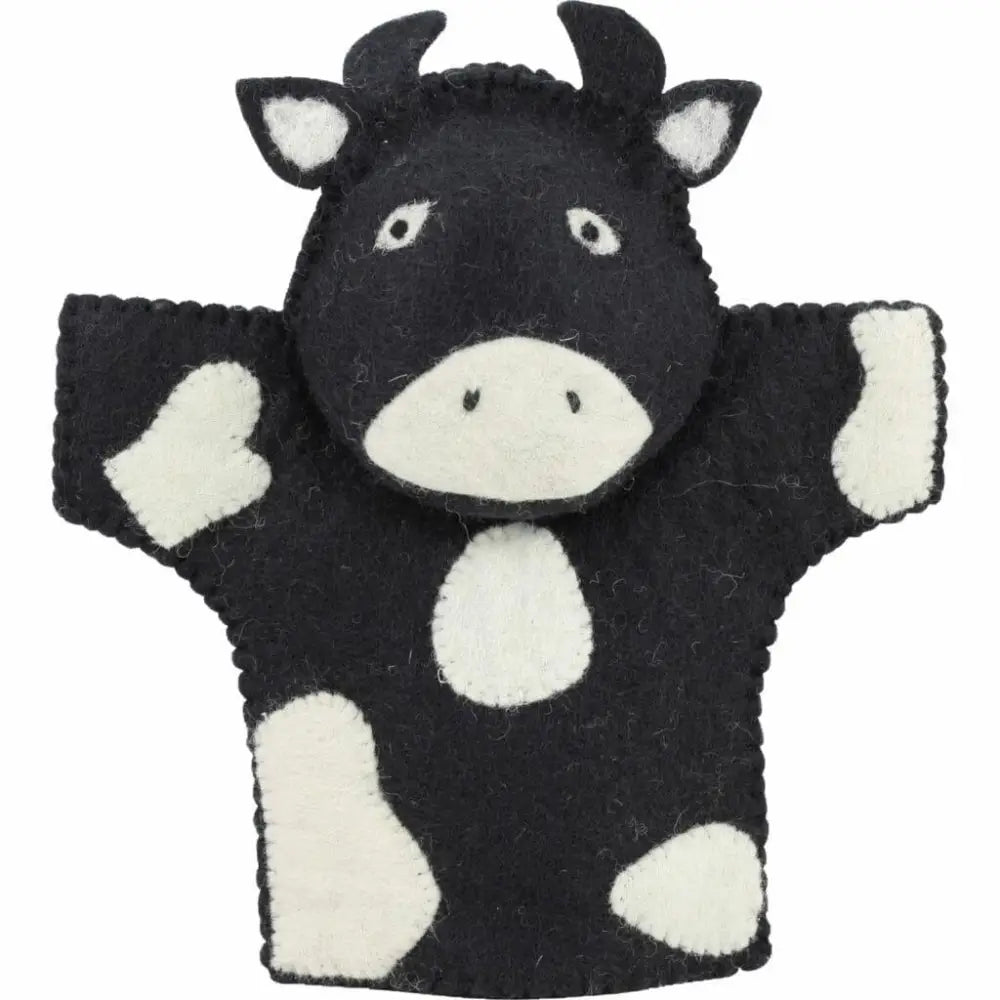 Black and white cow hand puppet with horns and raised arms.