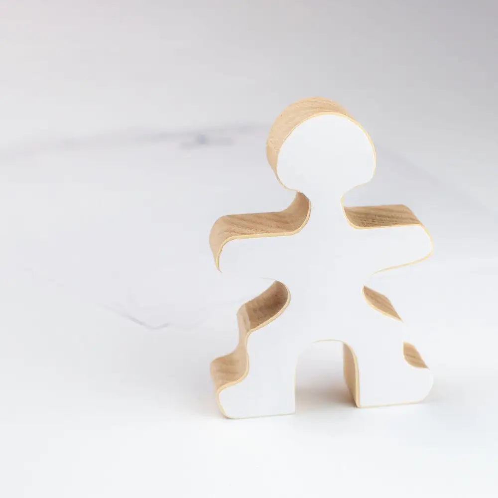 Stylized wooden figure in a simple human-like shape.