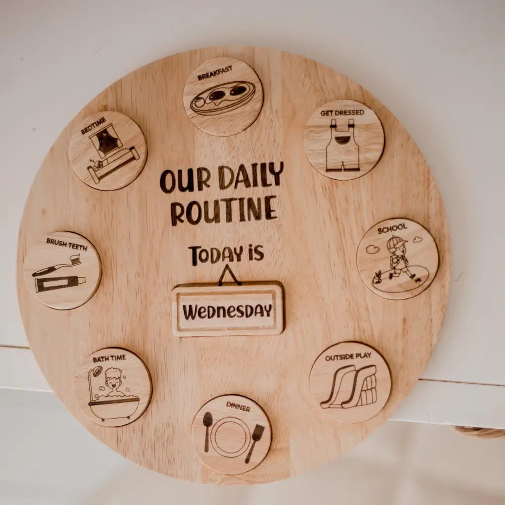 Wooden circular board displaying a daily routine schedule with icons for different activities.