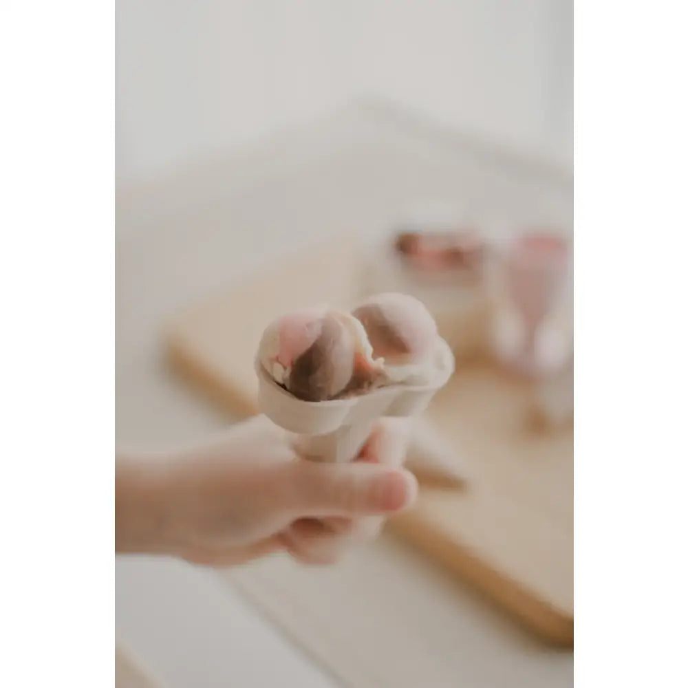 Ice cream cone held in a hand.