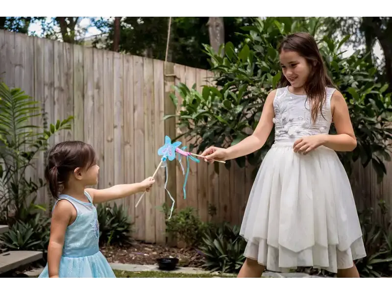 Two girls playing with a wand.