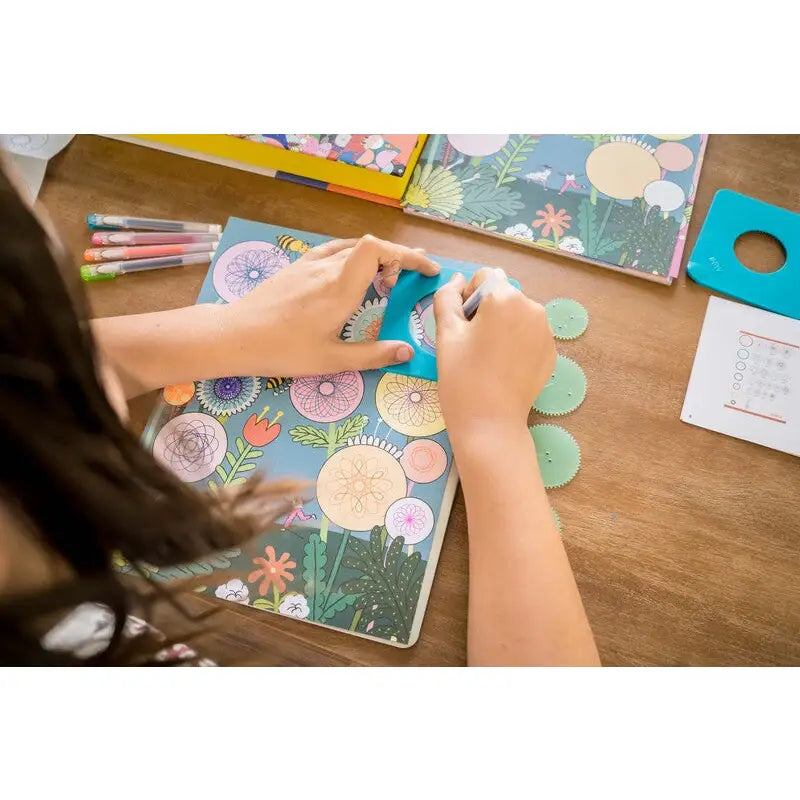 Colorful floral notebook or journal being written in with a pen.