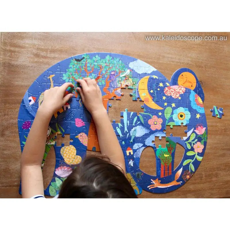 Colorful jigsaw puzzle with whimsical space-themed illustrations being assembled.