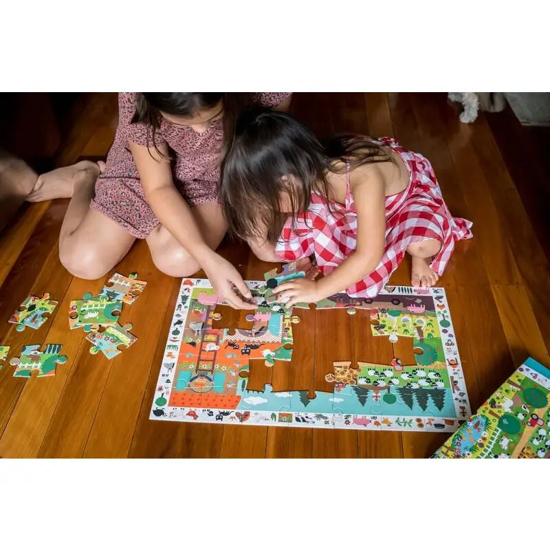 Puzzle being assembled by children on a wooden floor.