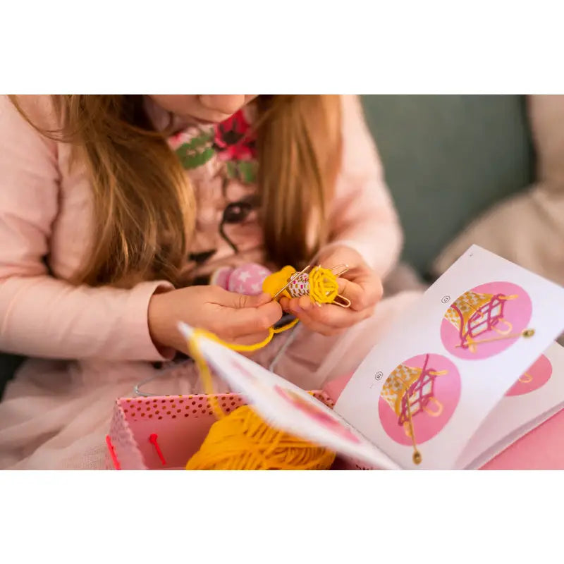 Child’s hands holding colorful craft supplies and stickers.