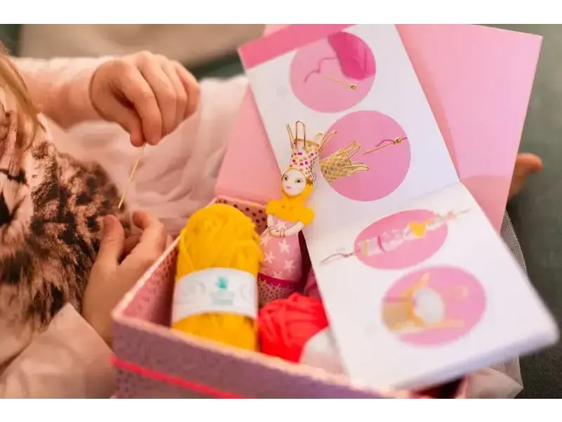 Gift box containing Easter-themed items like a chocolate bunny and colorful eggs.