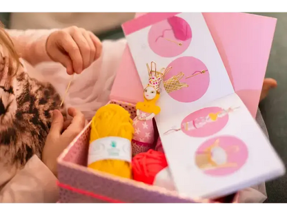 Gift box containing Easter-themed items like a chocolate bunny and colorful eggs.