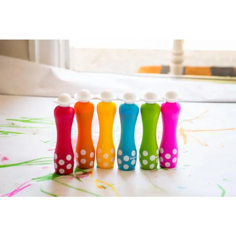 Colorful bowling pins with polka dot patterns arranged in a row.