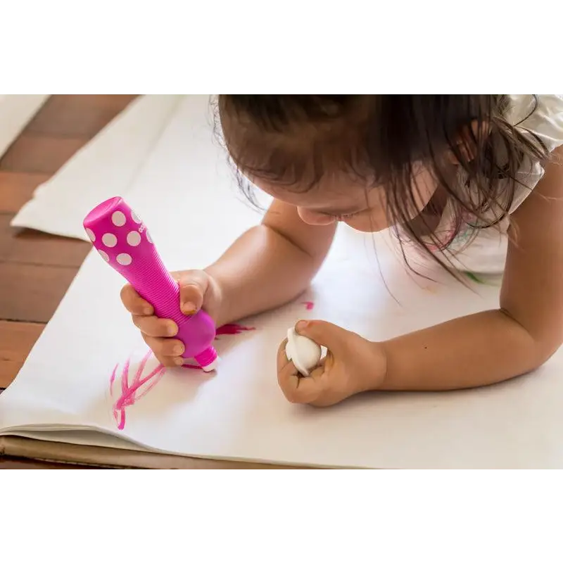 Child using a bright pink marker to draw on paper.