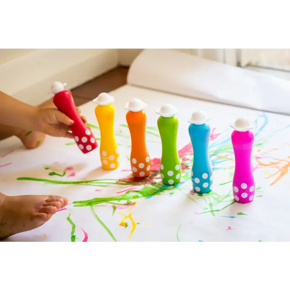 Colorful plastic bottles filled with paint arranged in a rainbow spectrum.