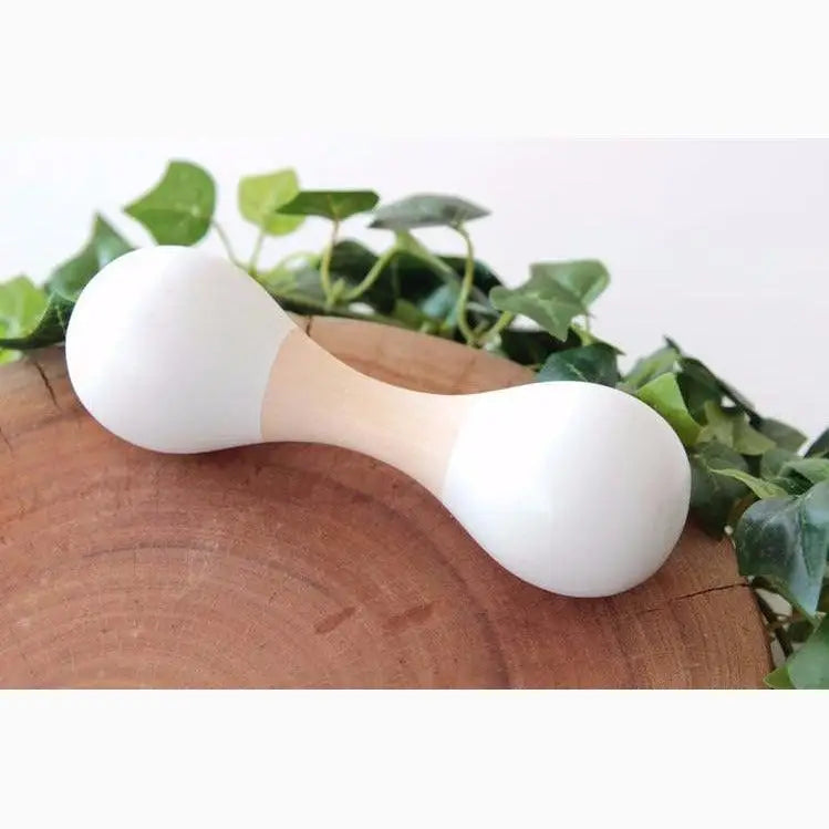 White hourglass-shaped massage tool with a wooden handle.