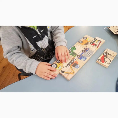 Wooden puzzle board with colorful vehicle shapes and numbers.