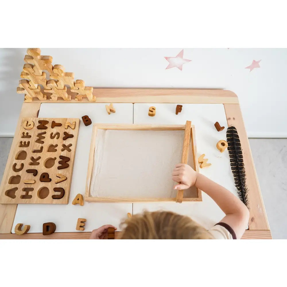 Wooden educational toy with alphabet letters and a drawing board.