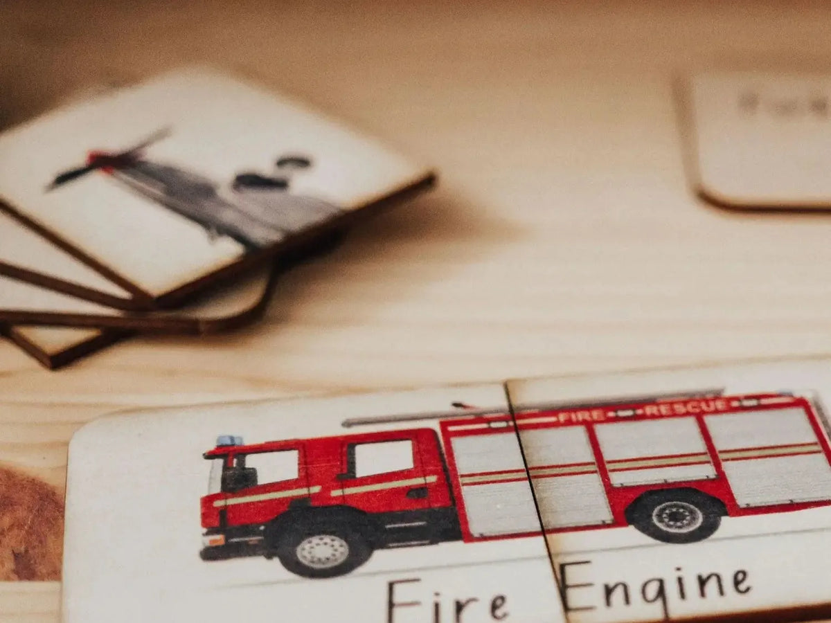 Red toy fire engine on a wooden puzzle piece.