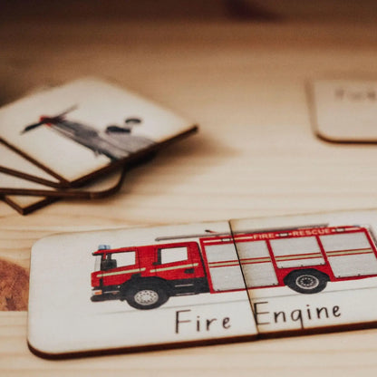 Red toy fire engine on a wooden puzzle piece.