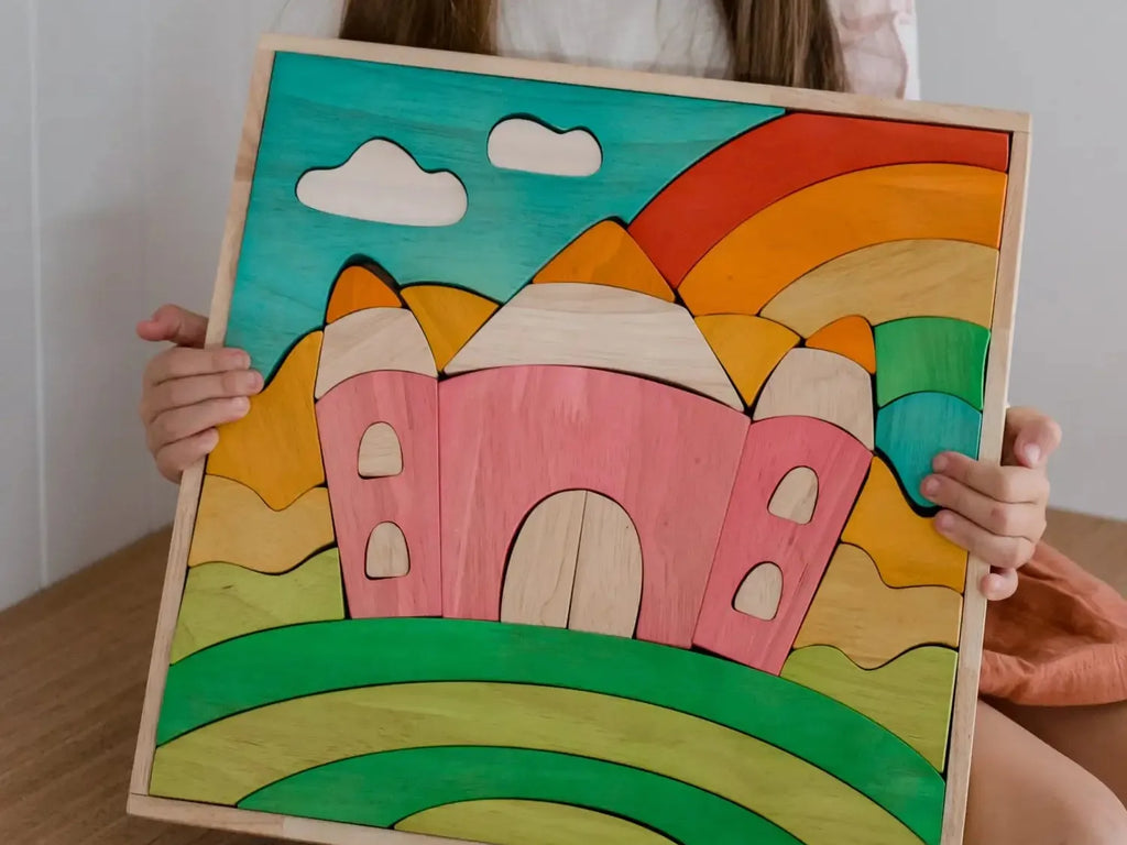 Colorful wooden puzzle depicting a whimsical landscape with a castle, rainbow, and clouds.