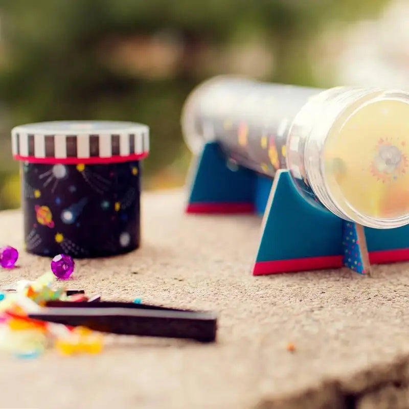 Colorful kaleidoscopes with decorative exteriors lying on a surface.