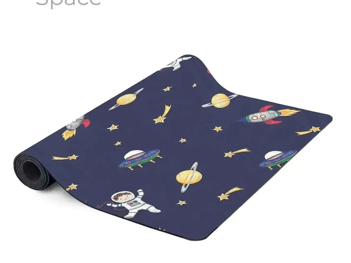 Space-themed yoga or exercise mat with colorful cartoon space motifs on a dark blue background.