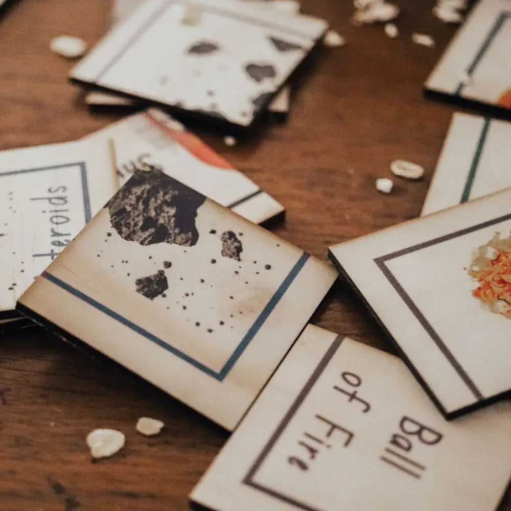 Scattered playing cards or game cards on a wooden surface.