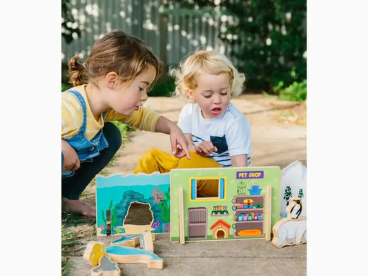 Colorful toy dollhouse or playhouse with multiple rooms and accessories.
