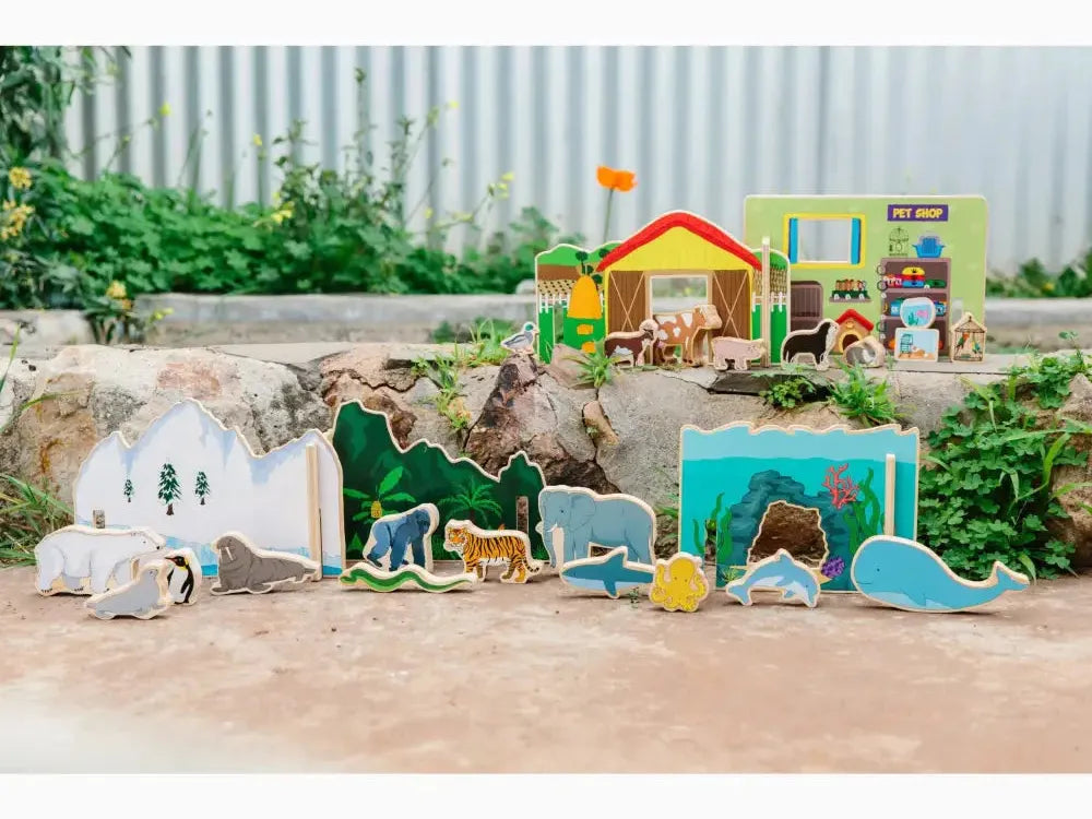 Colorful wooden toy set featuring various animals and habitats, including an igloo, forest, and underwater scenes.