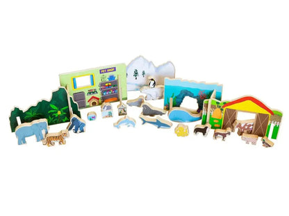 Collection of wooden toy animals, buildings, and play set pieces for a children’s zoo or wildlife park.