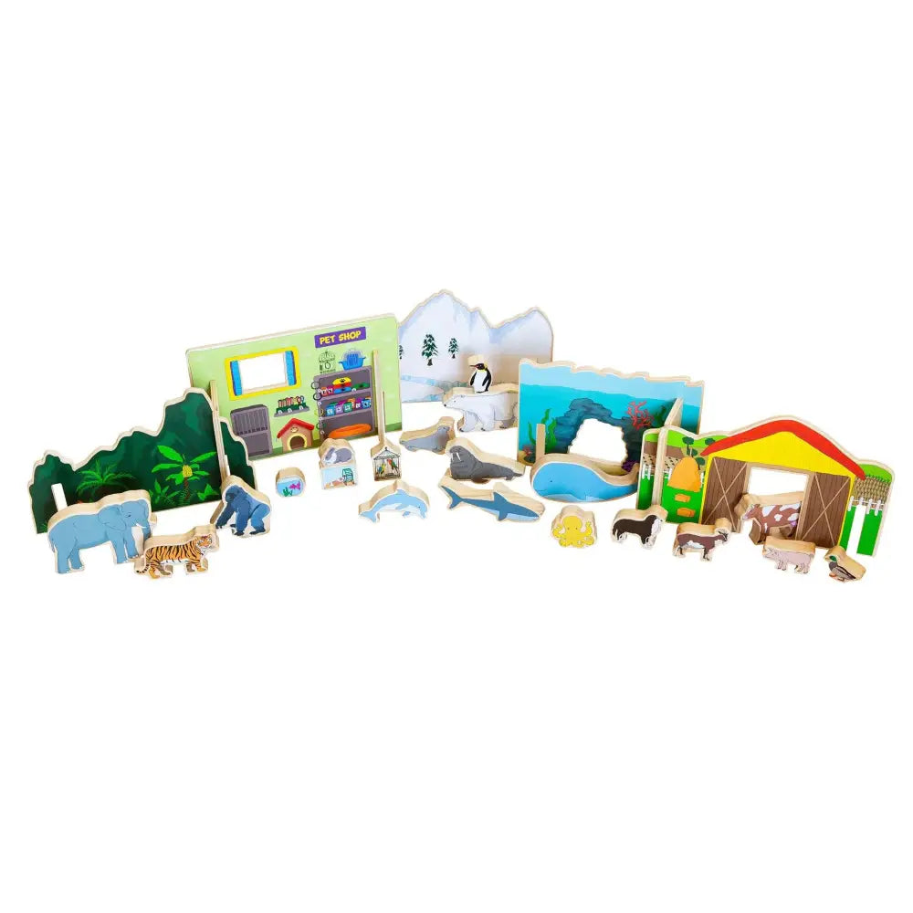 Collection of wooden toy animals, buildings, and play set pieces for a children’s zoo or wildlife park.