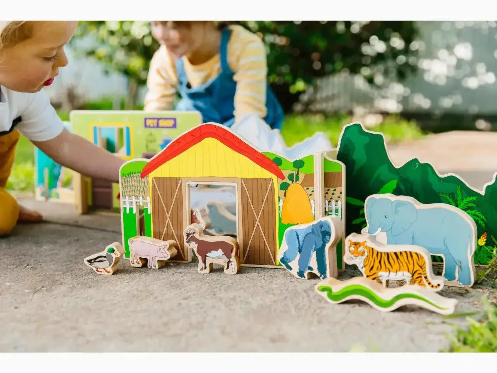 Colorful wooden toy farm set with animals and a barn.