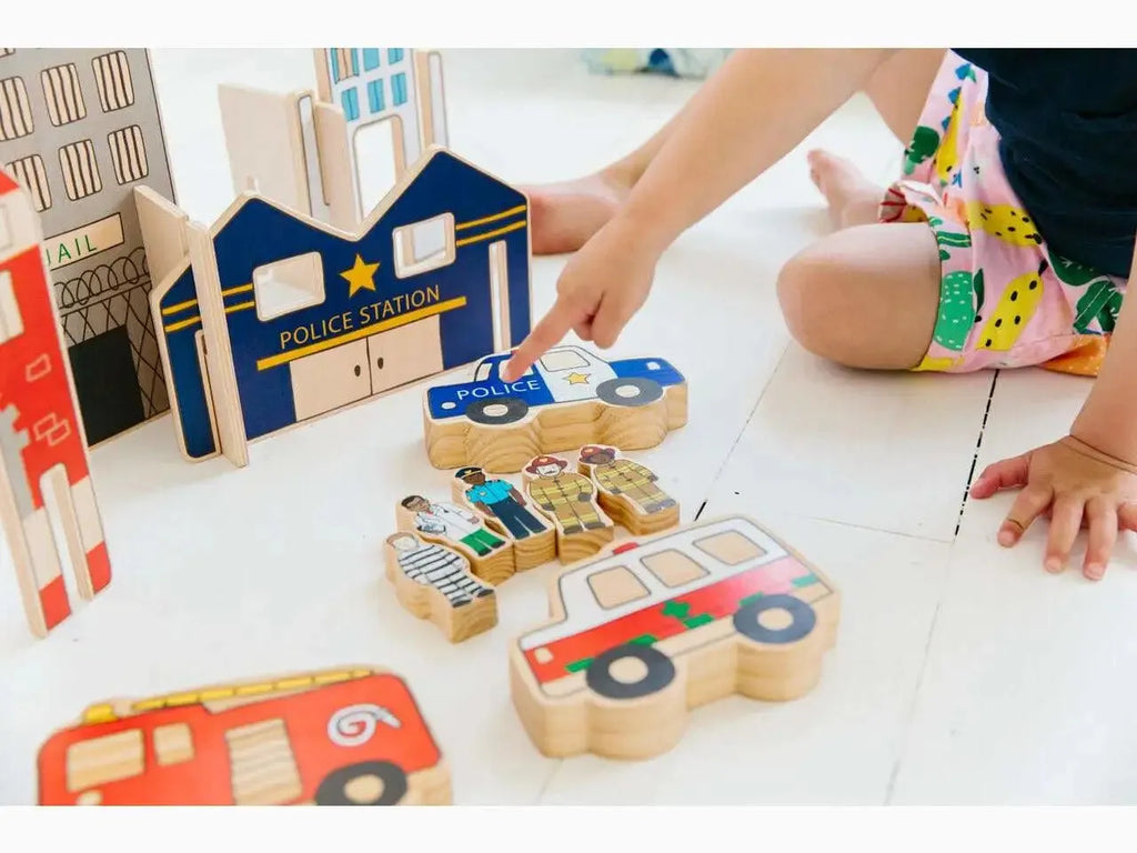 Wooden toy set featuring buildings, vehicles, and puzzle pieces for imaginative play.