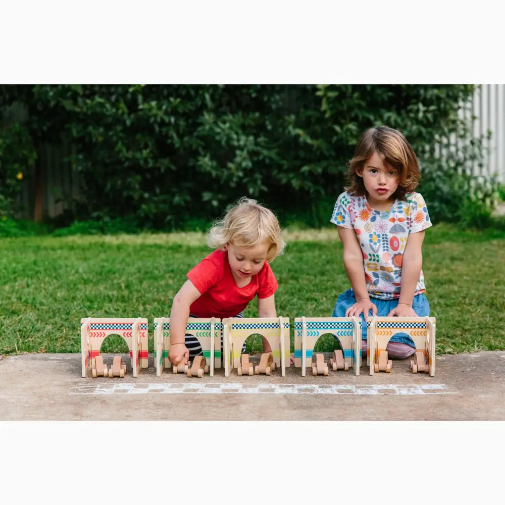 Wooden toy train set with arched windows and doors.