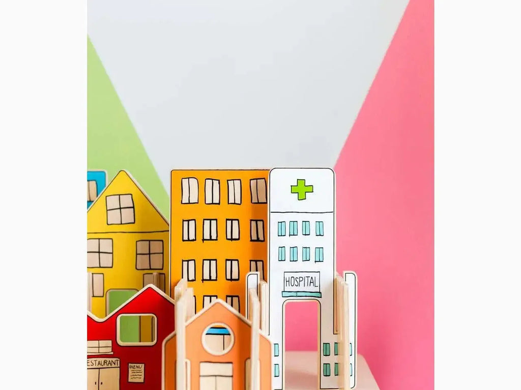 Colorful miniature wooden buildings representing a town or city, including houses and a hospital.