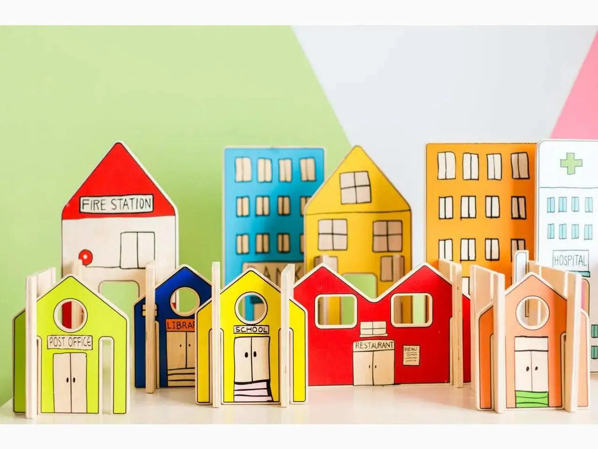 Colorful wooden toy buildings representing a miniature town or cityscape.
