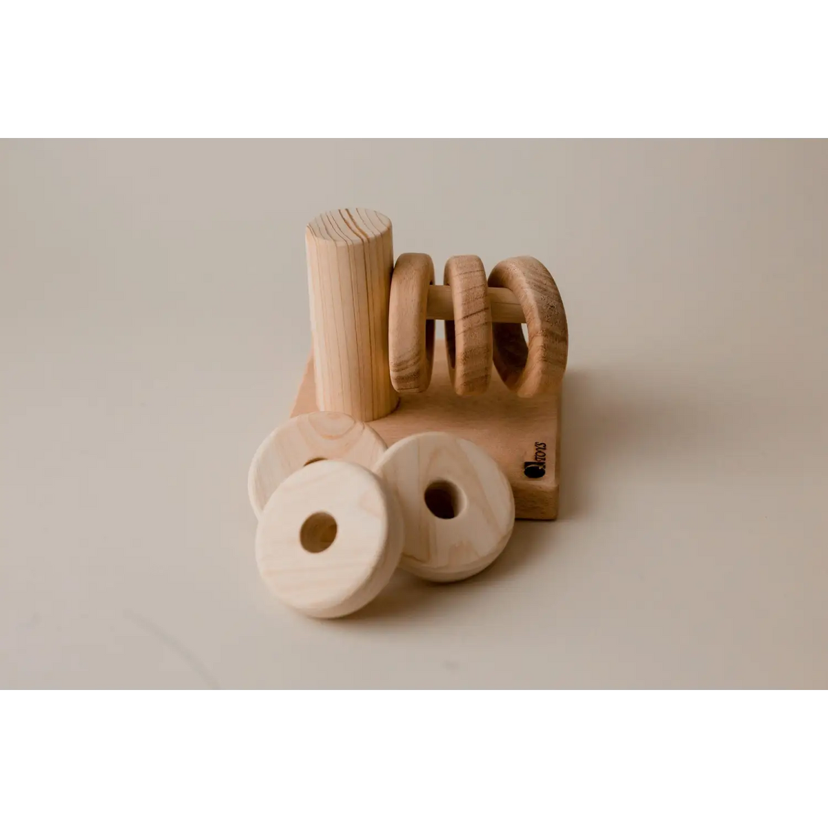 Wooden napkin holder with circular napkin rings.