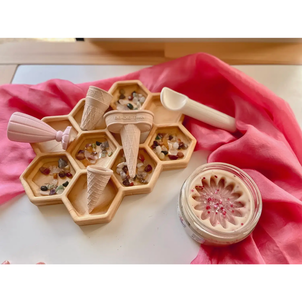 Wooden honeycomb-shaped organizer with compartments filled with various crystals and stones.