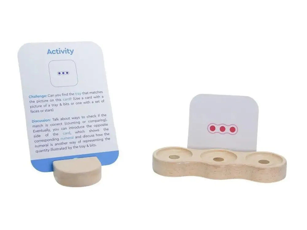 Wooden activity board with card holders and circular cutouts.