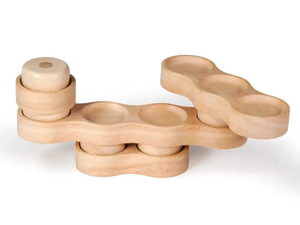 Wooden toy or puzzle piece with multiple circular indentations and a cylindrical component.