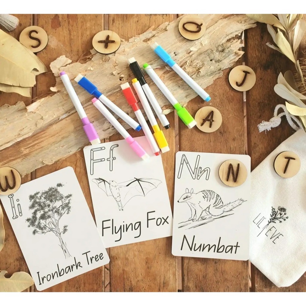 Educational materials for teaching alphabet and animal vocabulary, including flashcards, colored markers, and wooden letter pieces.