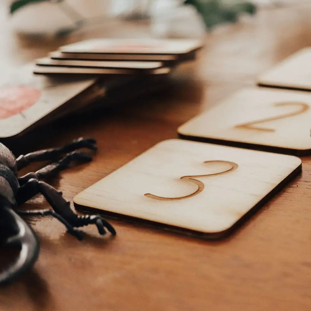 Wooden square tile with the number 3 engraved on it.